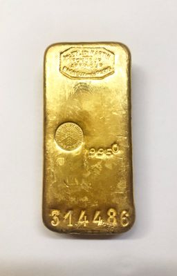 a close up of a gold bar on a white surface