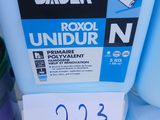a blue container with a label on it next to some other containers