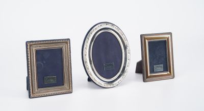 three picture frames sitting next to each other on a white surface