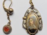 an image of a pair of earrings with a picture of a woman on it