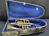 an old trumpet in a case on a table