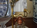 a glass of water sitting on a table next to a lamp