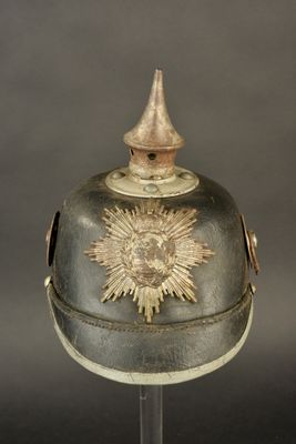 an old helmet with a star on the top of it on a stand