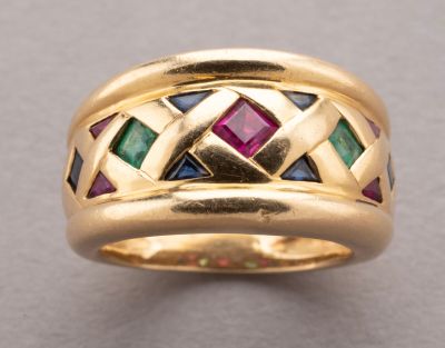 a close up of a gold ring with multi colored stones