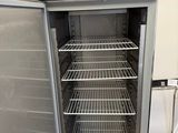an open refrigerator with a lot of shelves in it