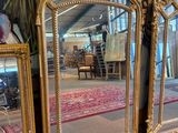 three mirrors that are sitting next to each other on the floor