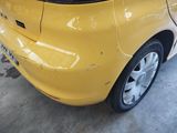 a yellow car that is parked in a garage