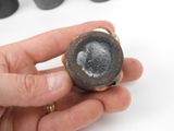 a person holding a ring that has a picture of a man on it