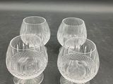 three clear glass wine glasses sitting on top of a table