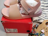 a box with a pair of shoes and a pair of slippers
