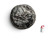 a close up of a coin on a white surface