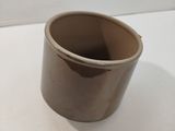 une tasse marron posée sur une table blanche