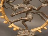 an image of a bronze statue of a woman dancing in a circle