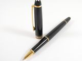 the pen is black and gold with a gold trim