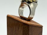 a close up of a ring on a wooden stand on a white background