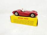 a red toy car sitting on top of a yellow box