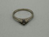 a close up of a ring on a table with a white background