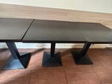 two tables that are sitting on a tiled floor