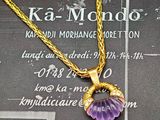 une chaîne en or avec un pendentif en forme de fleur violette