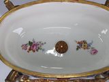 a white bowl with gold trim and flowers on it