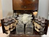 a wooden box with a bunch of empty glasses in it