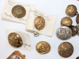 several different types of buttons are on a table with a note