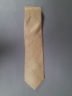 an image of a yellow necktie on a gray background