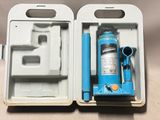 a box with a bottle of water and a pair of scissors in it