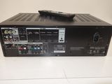 an image of a remote control sitting on top of a receiver