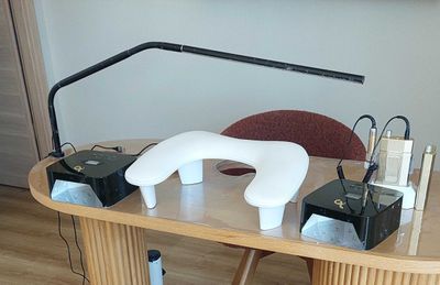 a desk with a lamp and some electronics on it