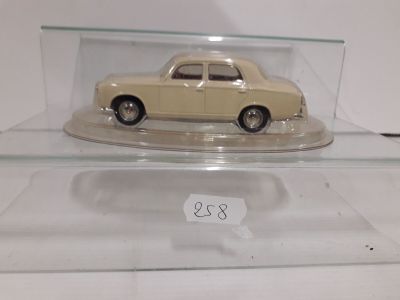 a small model of a car in a glass case