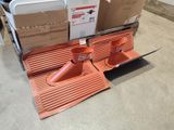 a pile of boxes and a pair of cones on the floor