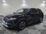 the black suv is parked on a checkered floor in a garage