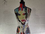 a mannequin with a painting of a woman ' s face on it