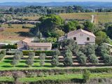 an aerial view of a house in the middle of a green field