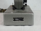 an old sewing machine sitting on a white surface