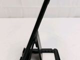 a tablet that is sitting on a stand on a table