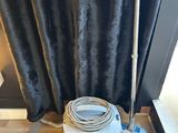 a vacuum that is sitting on the floor next to a window