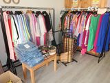 a lot of clothes hanging on a rack in a room