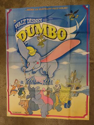 walt ' s dumbo movie poster with dumbo flying in the sky