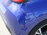a close up of a blue car ' s tail lights