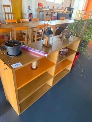 a wooden table with a pot on it in a room