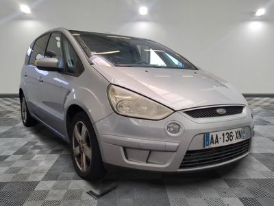a silver car that is parked on a checkered floor