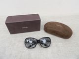 chanel sunglasses with box and case on a white surface