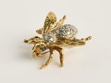 une image représentant une broche en forme d'abeille en or, dont les ailes sont ornées de diamants