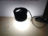 a lamp that is sitting on a table in front of a sign