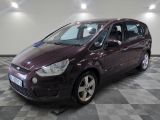 a picture of a maroon ford c - max parked on a checkered floor