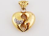 a yellow gold heart pendant with diamonds on a white background
