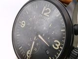 a close up of a watch on a white surface