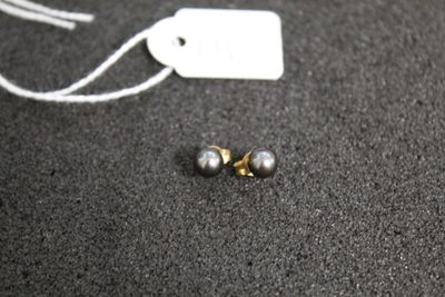 a pair of earrings that are laying on the floor